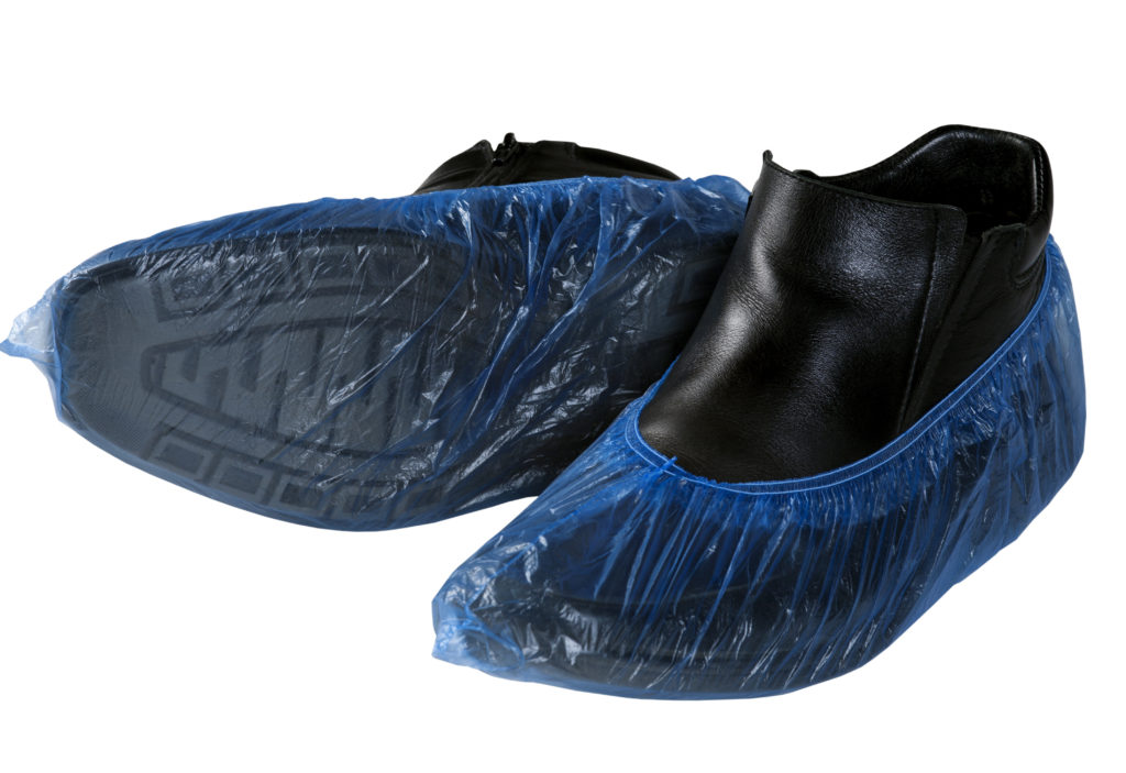 Shoe covers on nonslip food service shoes isolated on white background