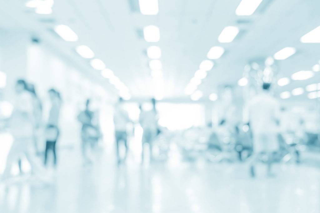 Blurred interior of hospital with disposable shoe cover systems.