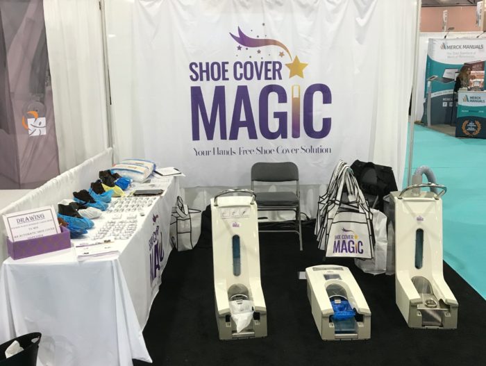 Tradeshow photo of shoe covers and hands-free applicator.
