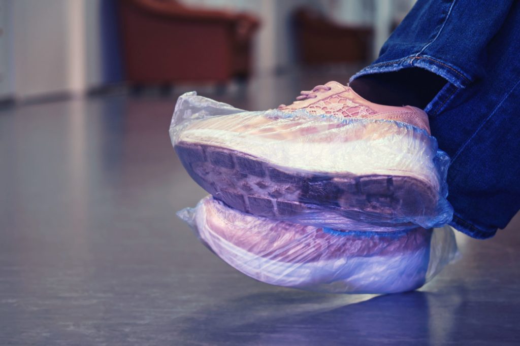 Shoe covers on sneakers to prevent the spread of bacteria..