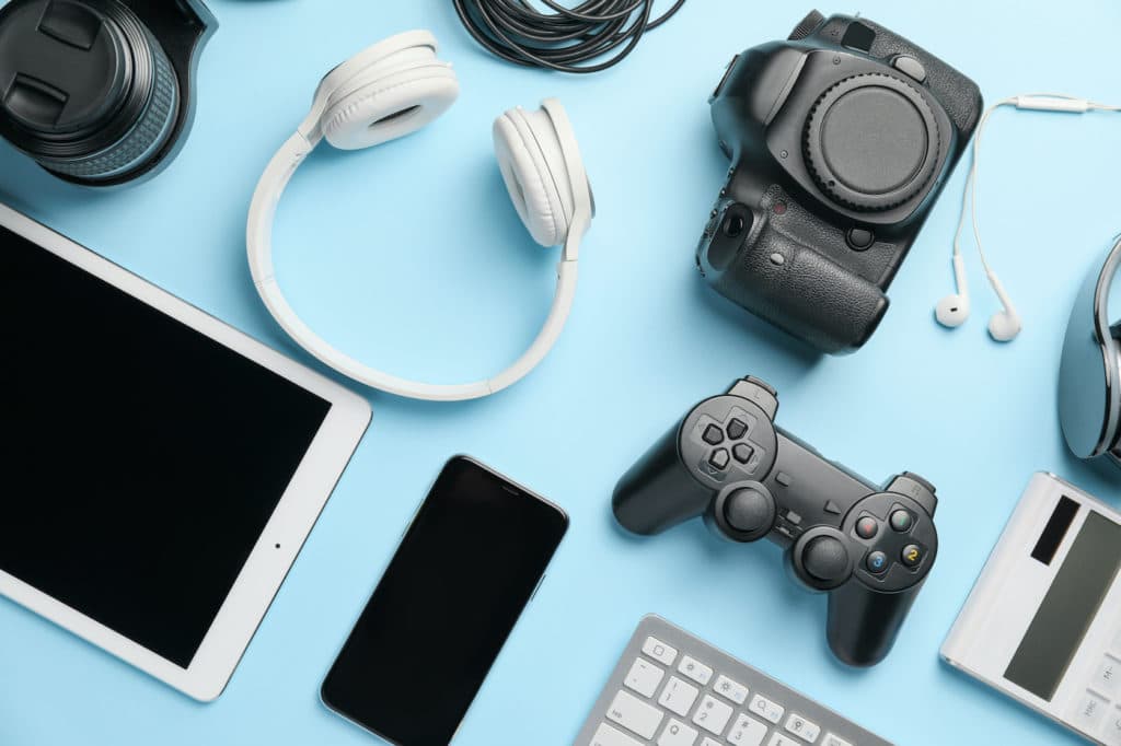Different electronic devices displayed on a blue table.
