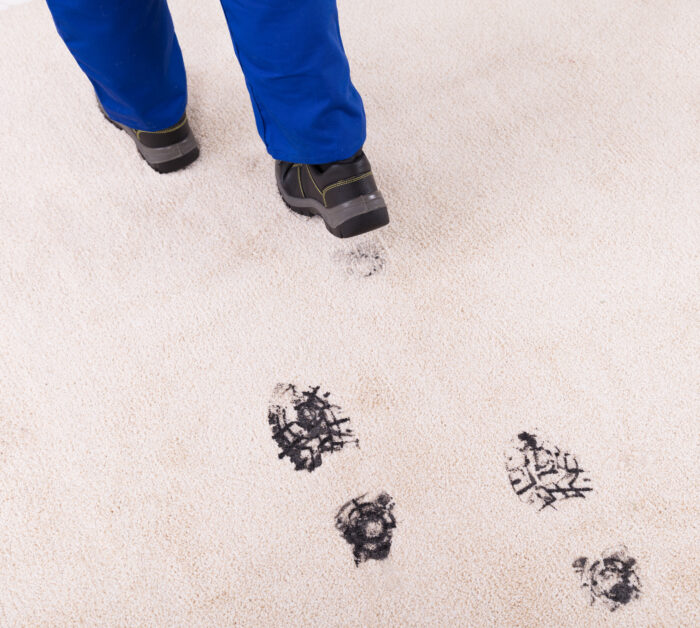Person tracking dirt and mud onto light carpet