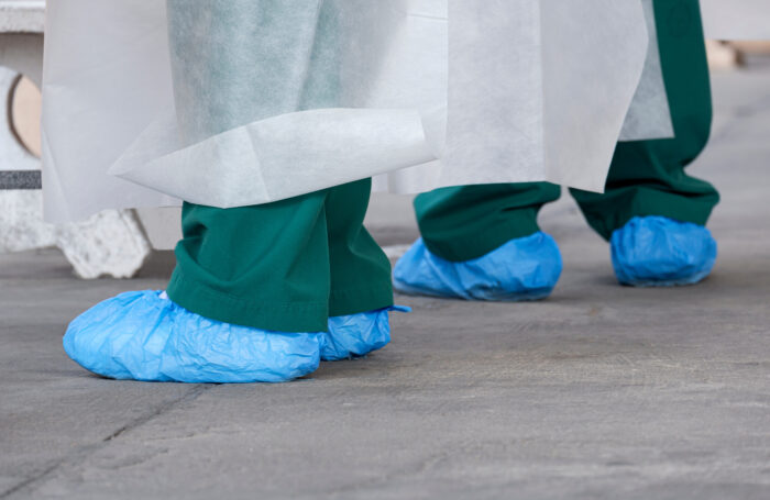 Nurse and doctor wearing protective shoe covers