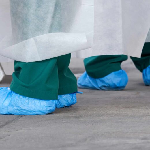 Nurse and doctor wearing protective shoe covers