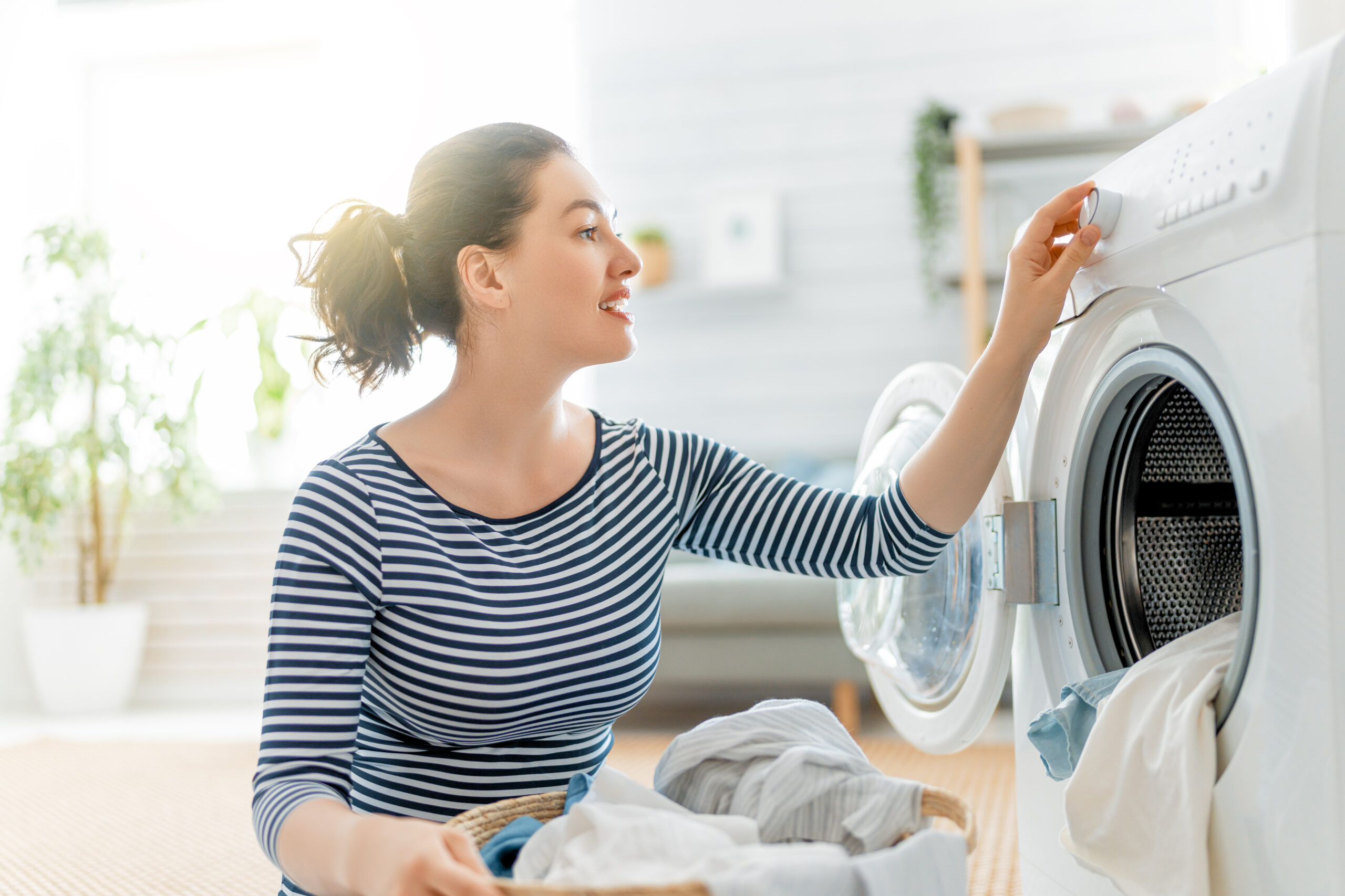Woman staying motivated while doing laundry