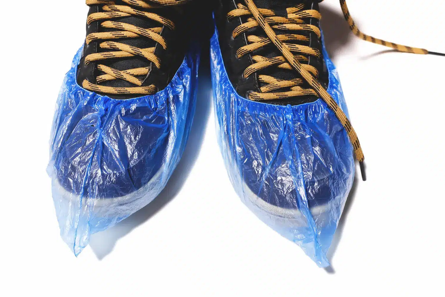 Daycare teacher shoes covered by plastic booties.