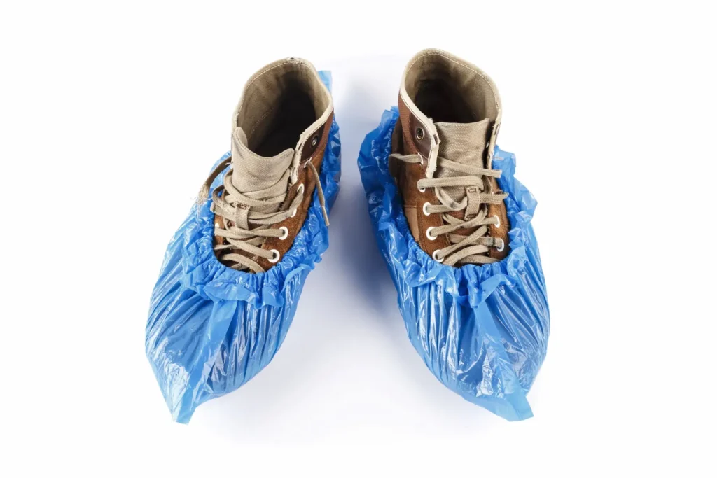 Internet and cable technician shoes covered by plastic booties.